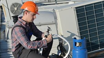 Man Giving Thumbs Up While Performing AC Installation in Heathrow