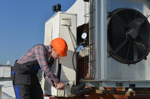 Man performing Air Conditioning Service in Lake Mary, Debary, Sanford, Orange City, and Surrounding Areas